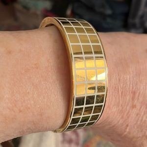 KATE SPADE GOLD-TONE WITH WHITE GRID PATTERN.SMALL TO MEDIUM WRISTS.